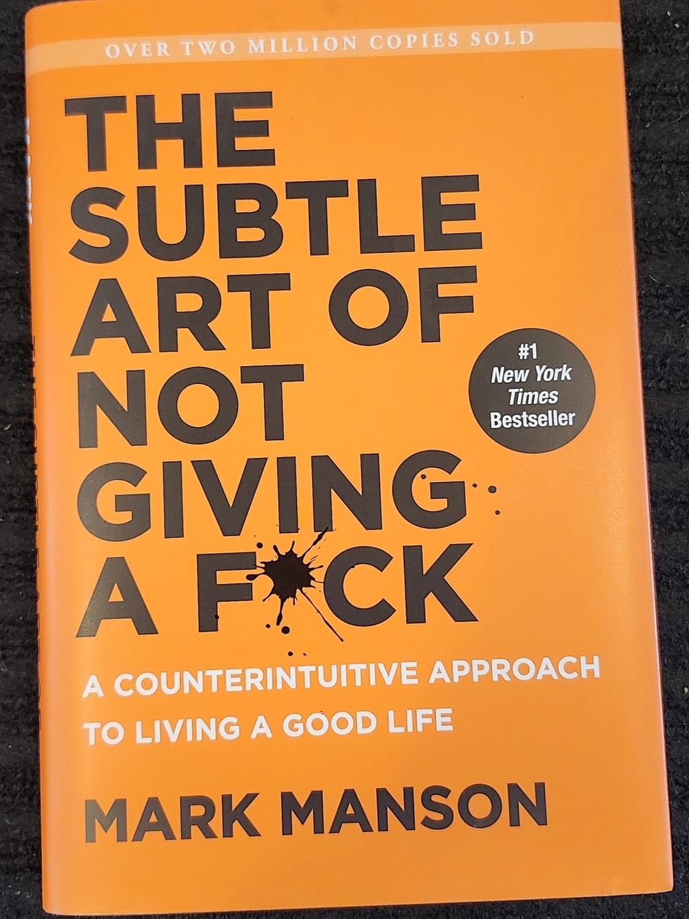 The Subtle Art of Not Giving a F*ck by Mark Manson - Bright Orange Paperback